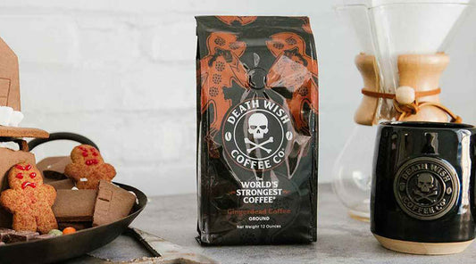 A countertop showing a bag of Gingerdead coffee, a black Death Wish Coffee Mug, and a Gingerdead Cookie