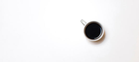 A cup of coffee in a white mug.