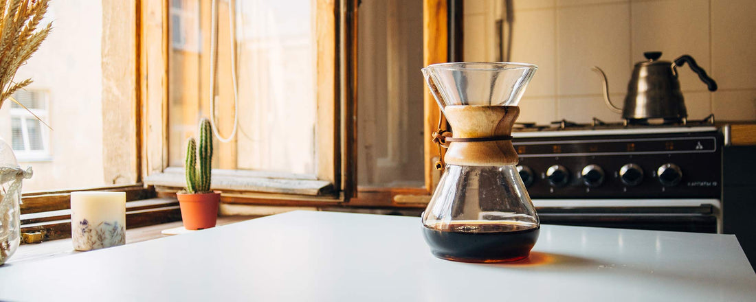 A coffee Chemex on a white kitchen countertop.