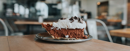 A table with a slice of chocolate midnight pie on a plate.