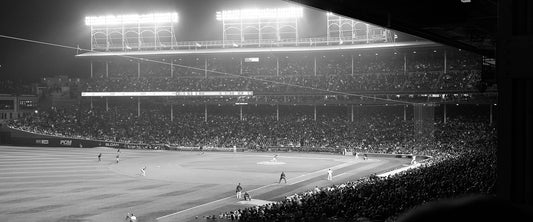 A black and white photo of a baseball game. [Featured Image Source: Ryan Arnst via Unsplash]