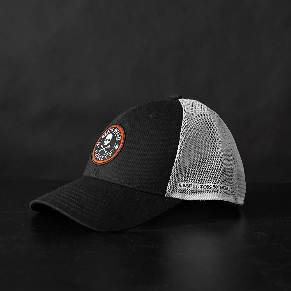 The left side of the Death Wish Coffee Rebellious By Nature Trucker Hat.
