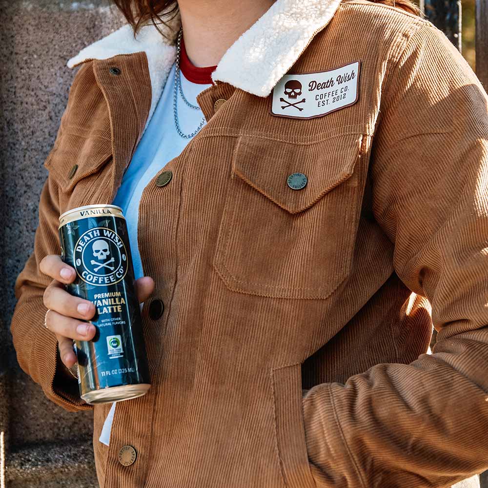 A model wearing the Death Wish Coffee Daily Grind Women's Corduroy Workwear Jacket.