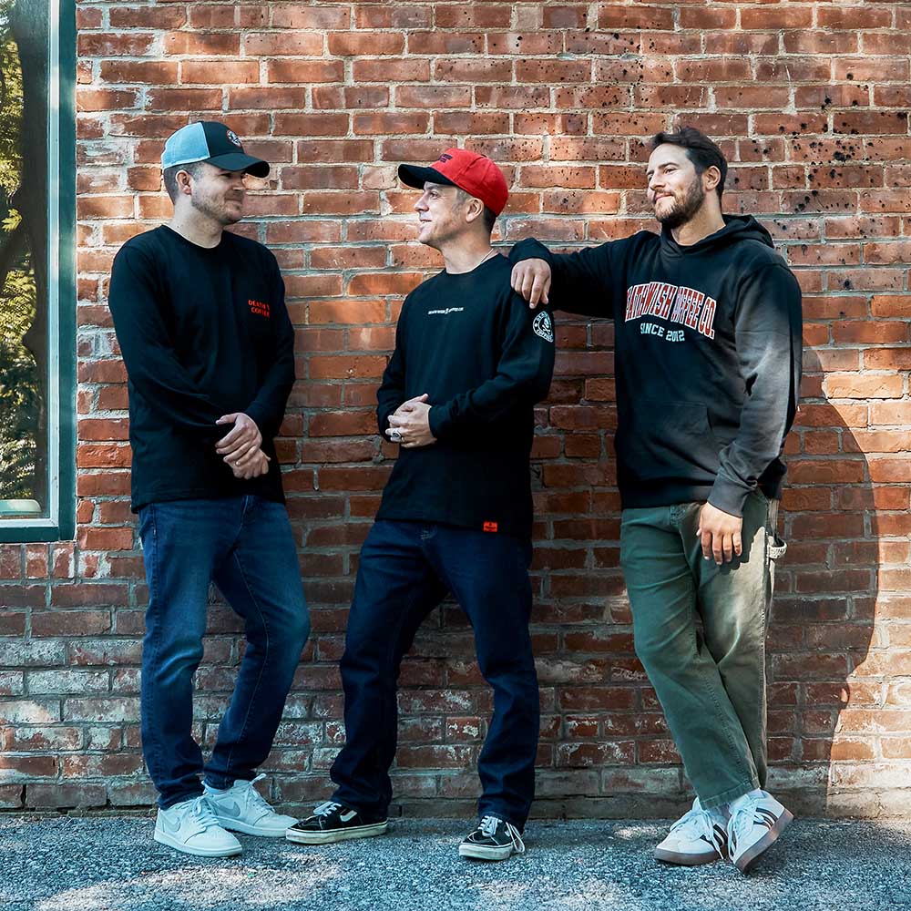 A model wearing the Death Wish Coffee Varsity Brews Hoodie.