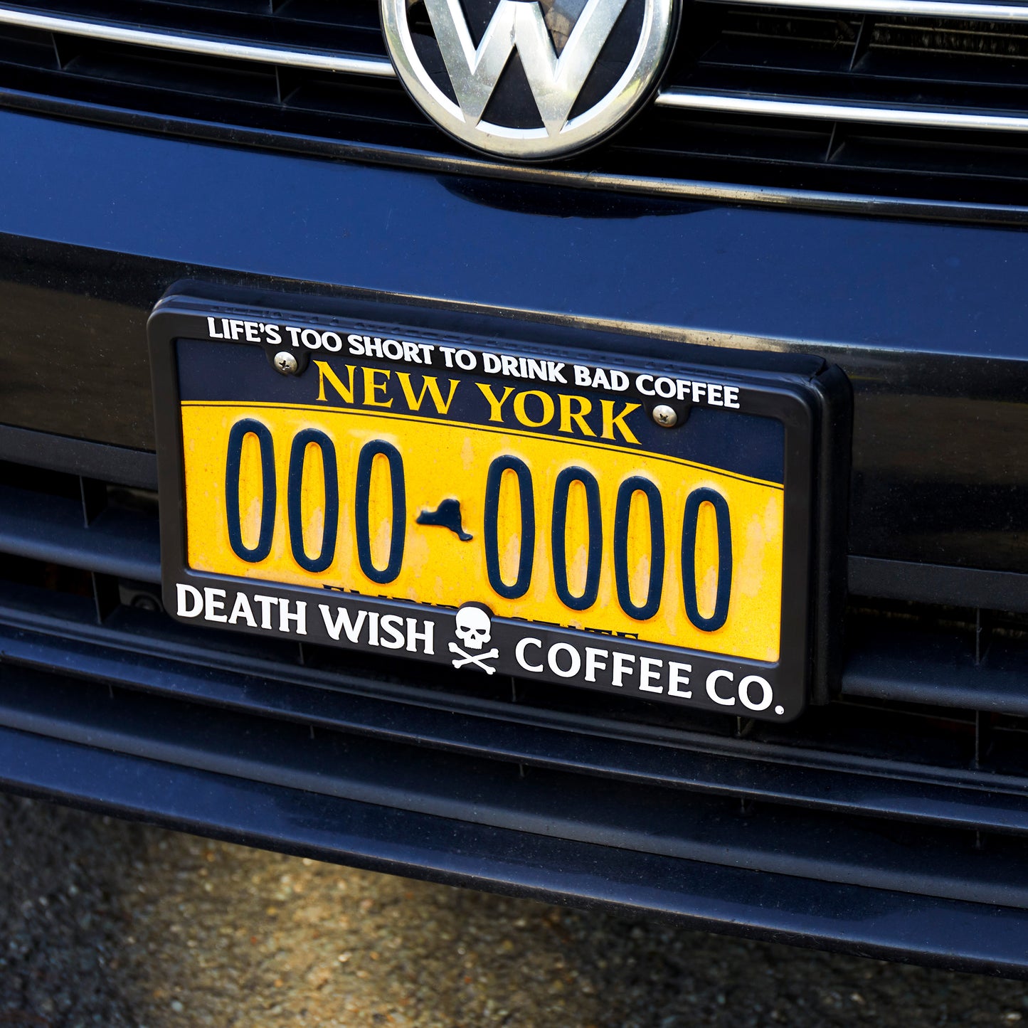 The Death Wish Coffee Fast Lane License Plate Frame on the front of a car.