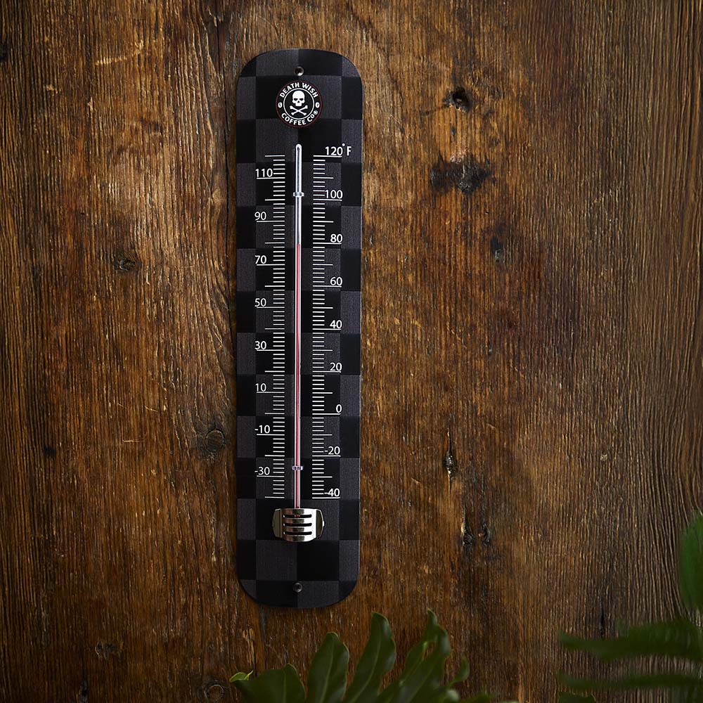 The Death Wish Coffee Boiling Point Wall Thermometer on a wall.