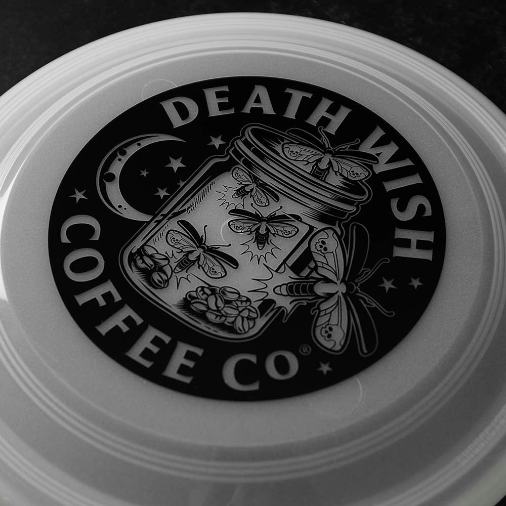 A close up of the Death Wish Coffee Glow to Hell Frisbee.