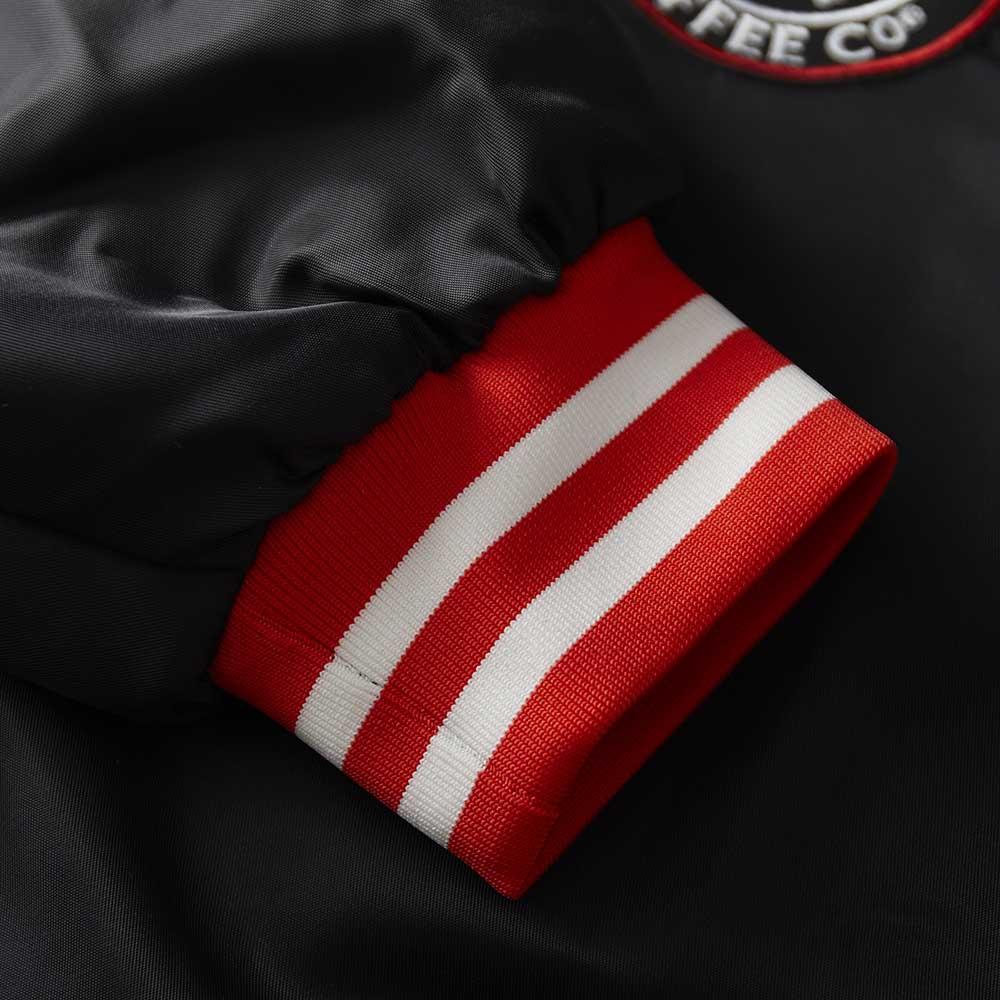 The cuff details of the Death Wish Coffee Level Up Letterman Jacket.