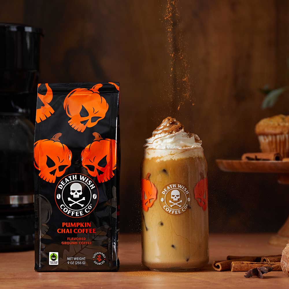Topping off Death Wish Coffee Pumpkin Chai Flavored Coffee with cinnamon.