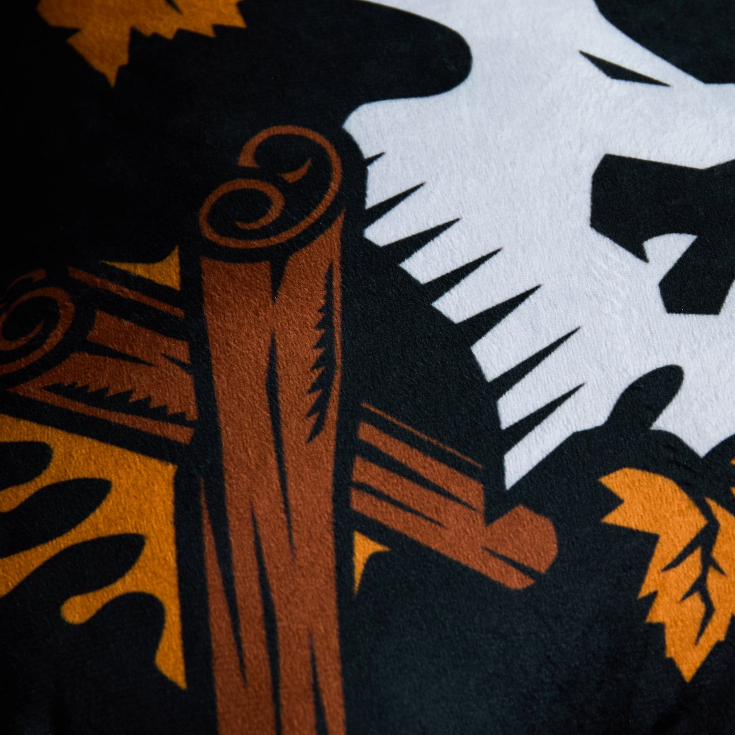 A close up of the Death Wish Coffee Maple Cinnamon Flavor Skull Pillow.