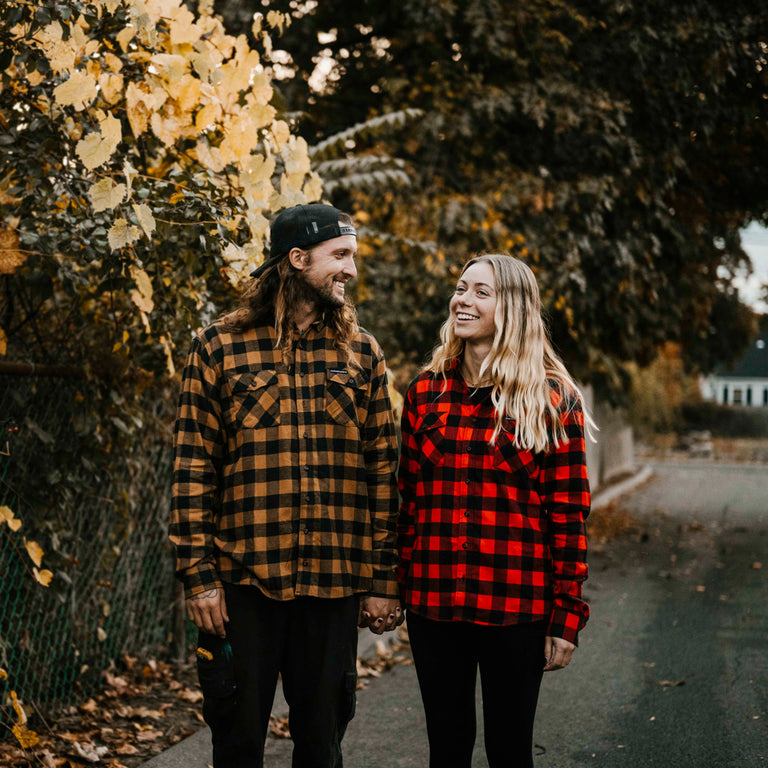 A couple wearing the Death Wish Coffee Dark Roast + Medium Roast Flannels