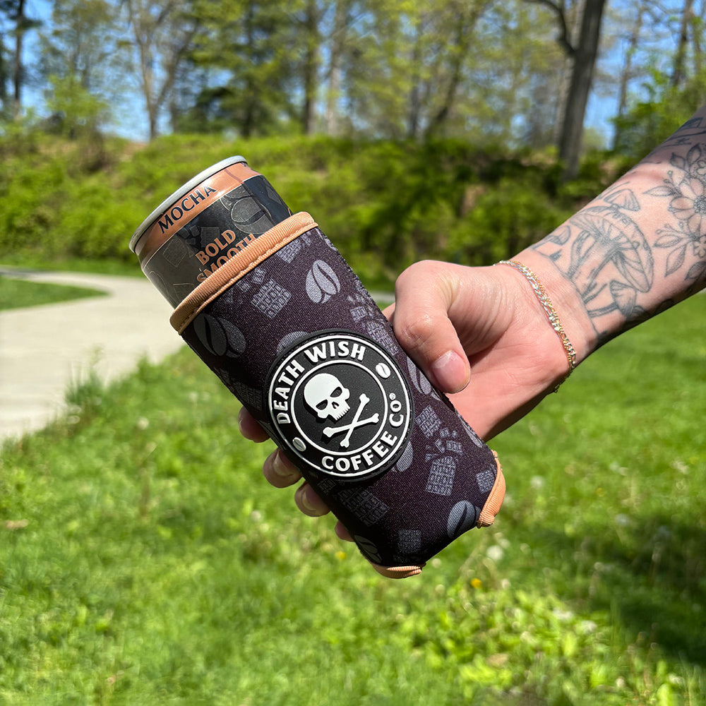 A hand holding the Death Wish Coffee Mocha Slim Can Koozie.
