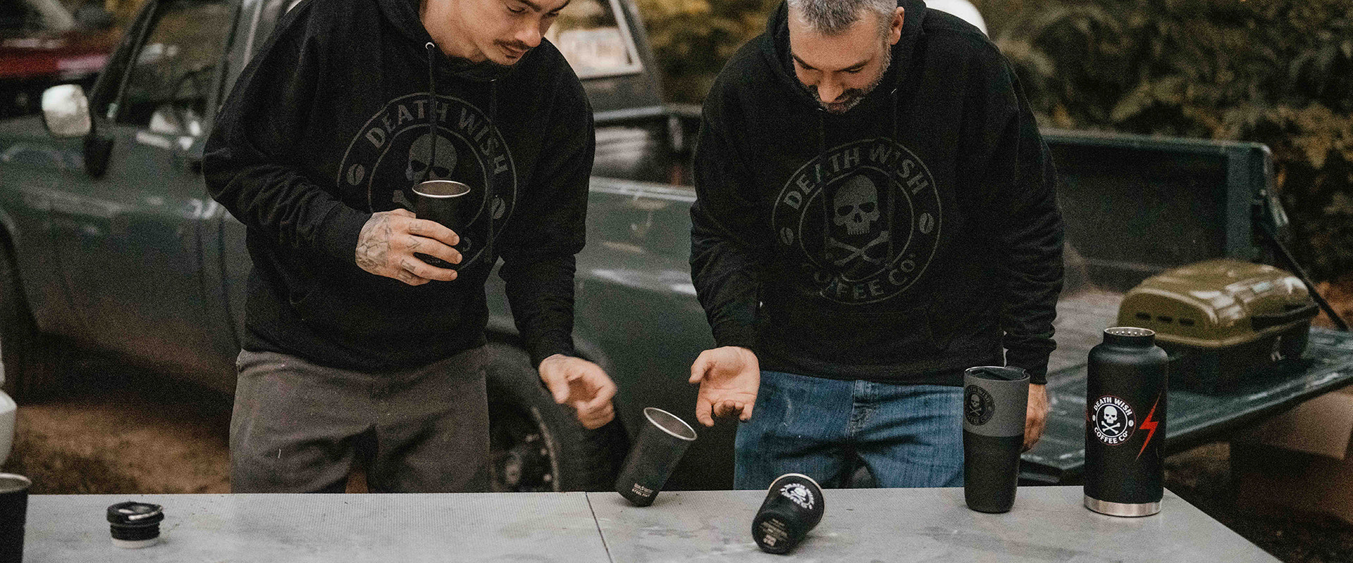 Two guys playing flip cup with coffee and the Death Wish Coffee Camping Bundle.