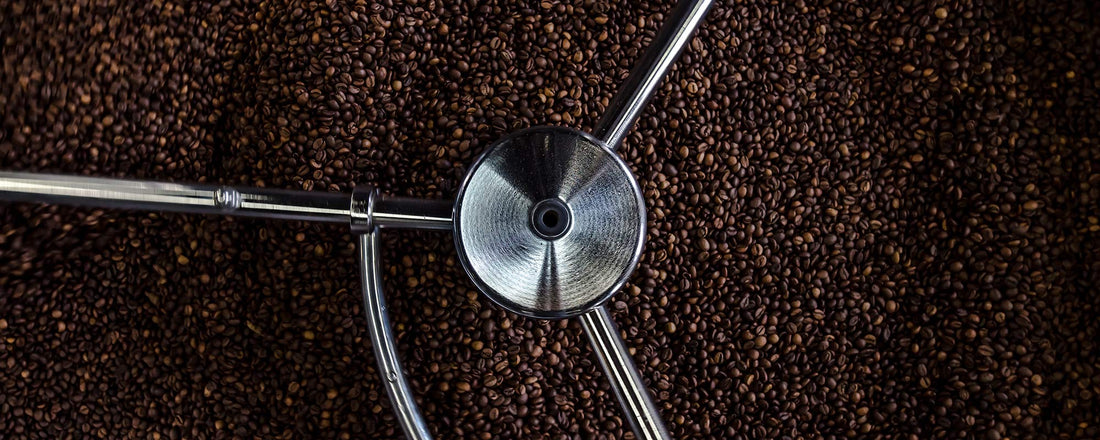 An aerial view of a coffee roaster filled with organic and fair trade coffee beans.