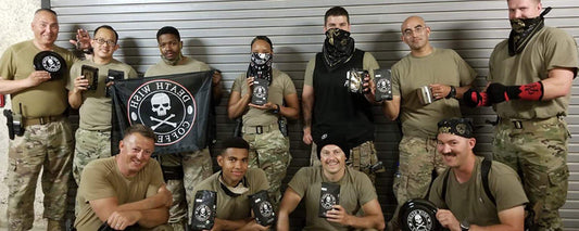 U.S. armed forces holding Death Wish Coffee bags and flags.