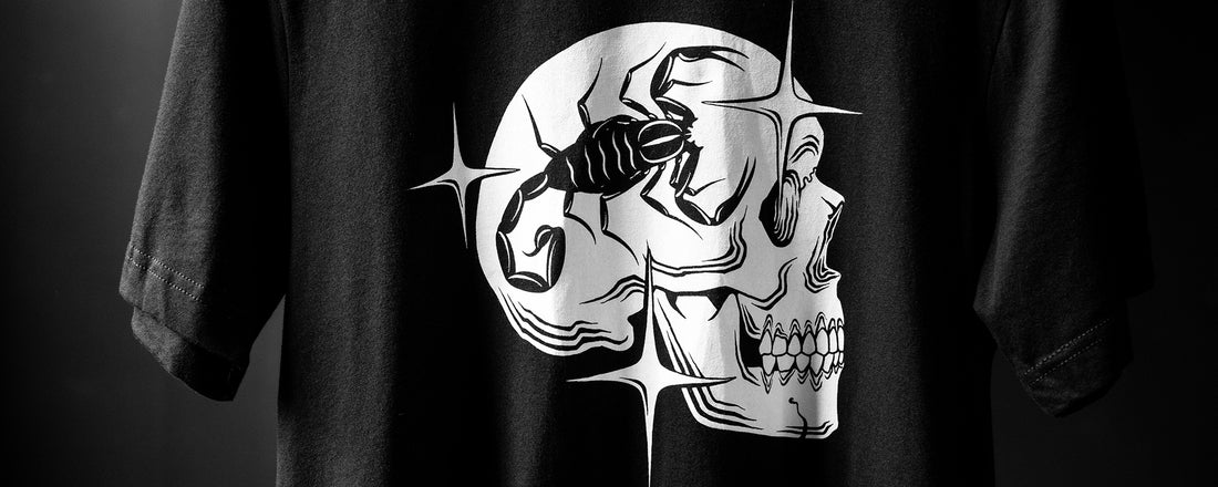 A black t-shirt with a scorpion skull mug design created by a tattoo artist.