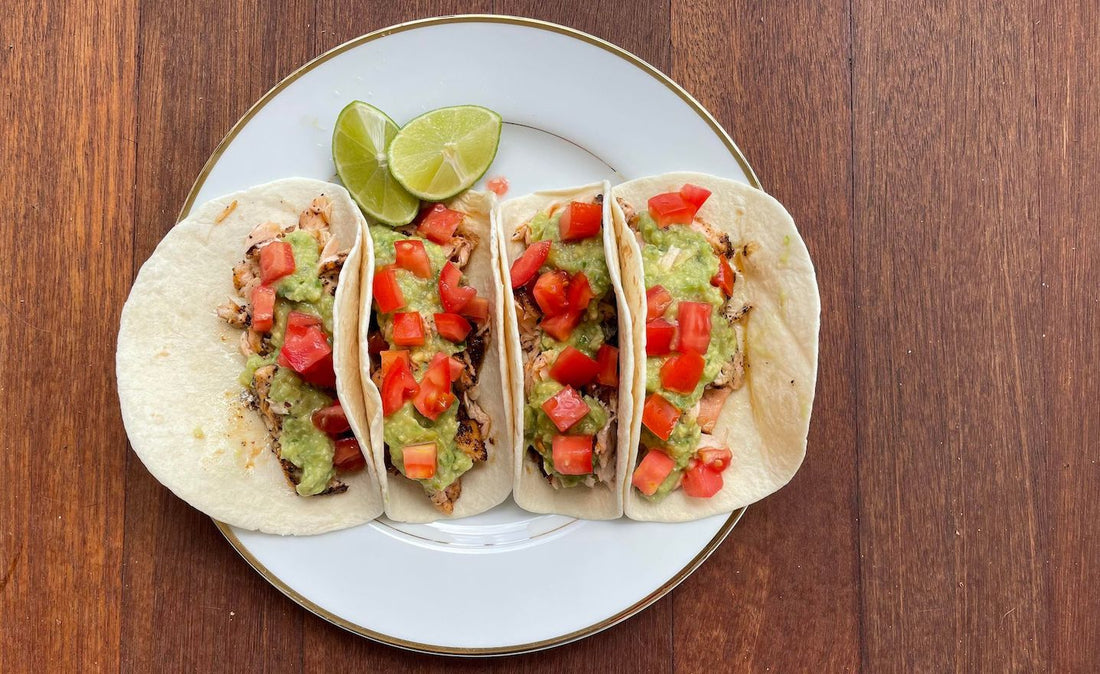 Salmon tacos on white plate