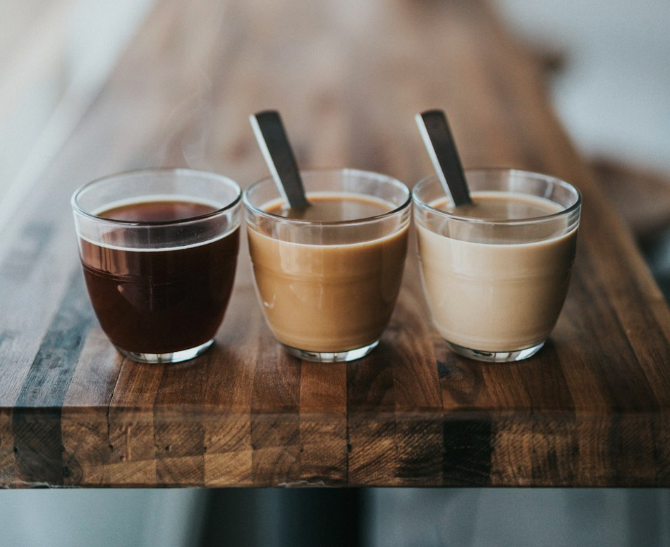 A group of coffee cups lined up next to each other.