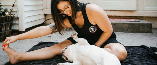 Stretching before a workout in the Death Wish Coffee Lights Out Tank Top.