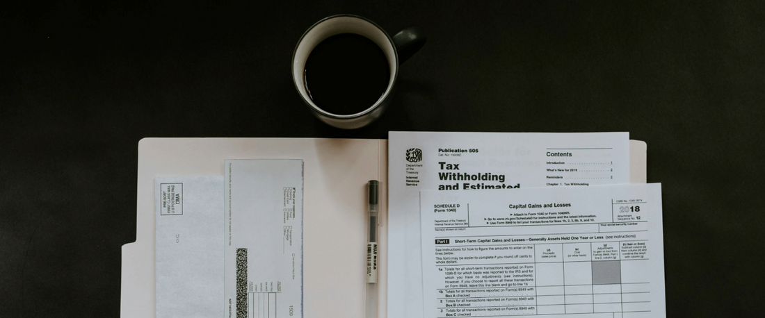 A folder of taxes fueled by a bold cup of coffee.