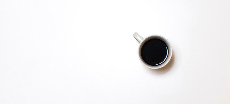 A cup of coffee in a white mug.