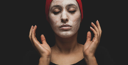 A woman applying a DIY coffee mask facial.