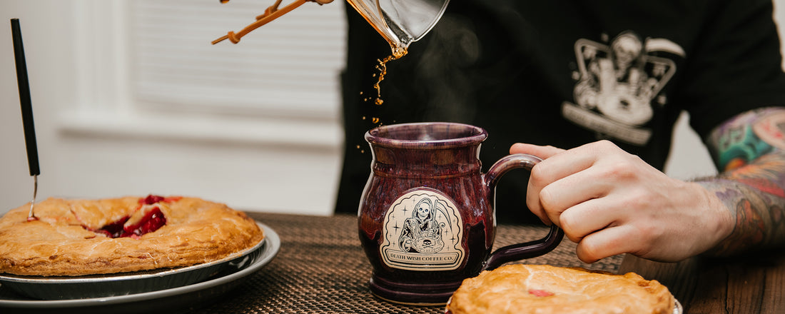 A man pouring hot coffee into a mug with a Pi Day design on it.