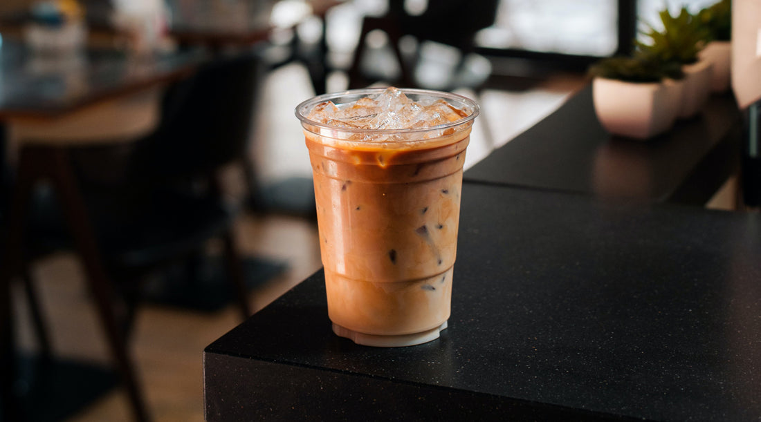 Iced coffee on a countertop in a coffee shop.