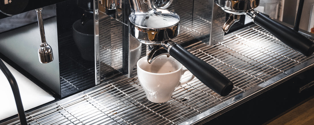 An espresso machine with a shot of espresso ready to be brewed. Photo Credit: James Kovin via Unsplash.