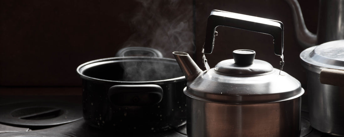 A pot warming up coffee on stovetop. Photo Credit: Lucas George Wendt via Unsplash.