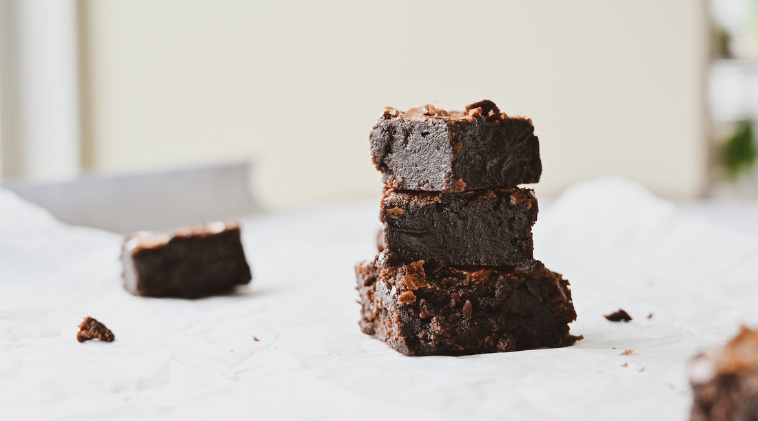Brownies stack on top of one another on white background