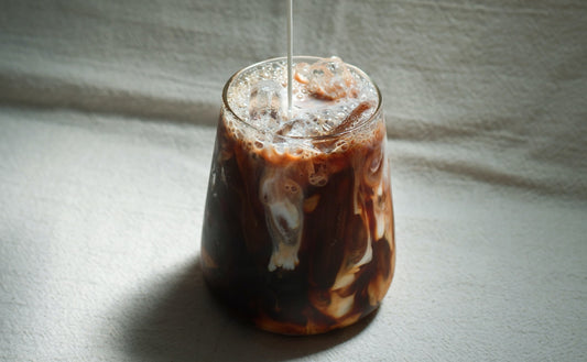 hand holding an iced coffee