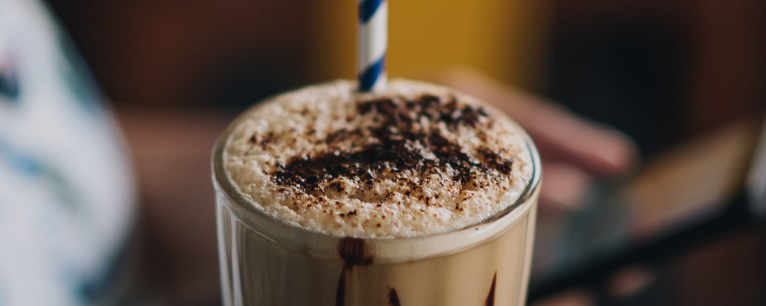 A coffee smoothie topped with cacao powder. Photo Credit:  Pratiksha Mohanty via Unsplash.  