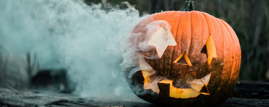 A jack-o-lantern with blue smoke coming out of its eyes.