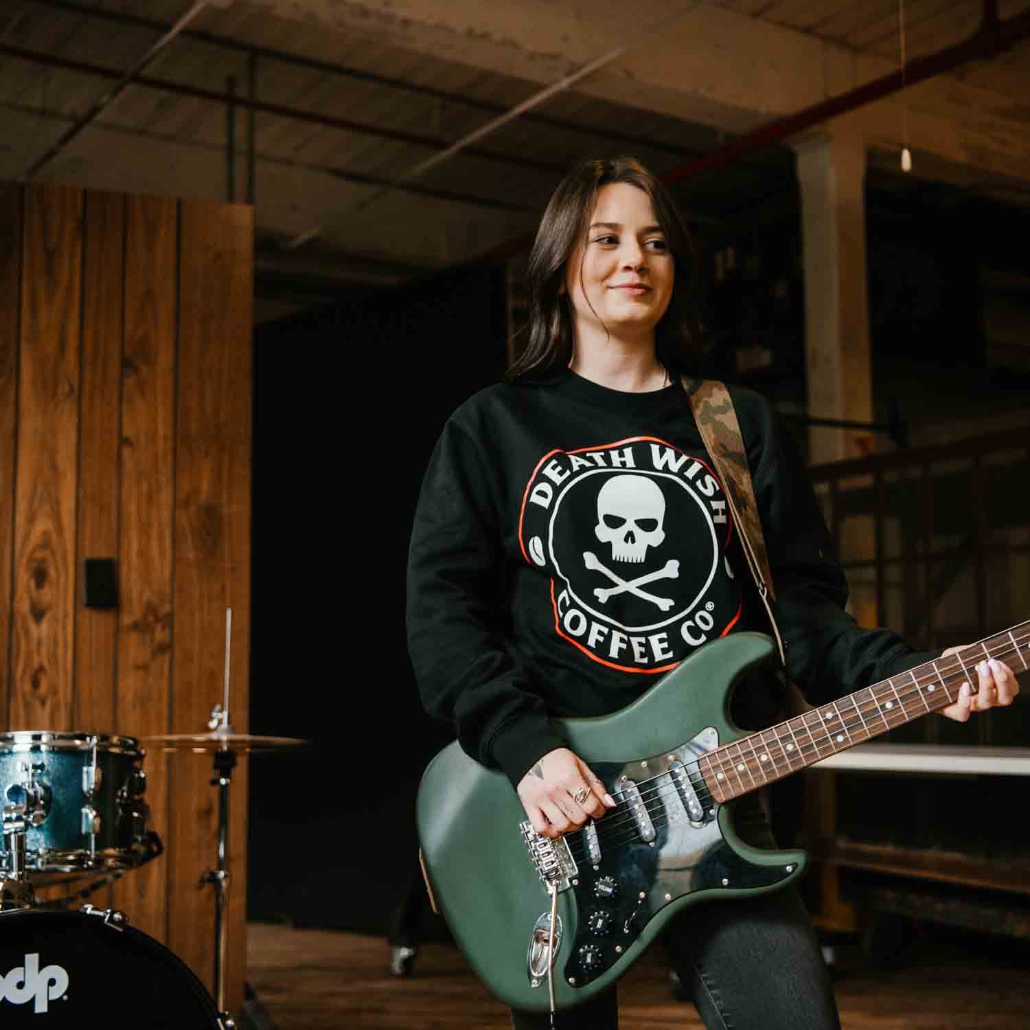 Playing guitar in the Death Wish Coffee Classic Logo Crewneck.