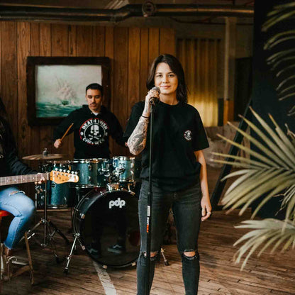 Gripping the microphone at band practice in the Death Wish Coffee Classic Pocket Tee.