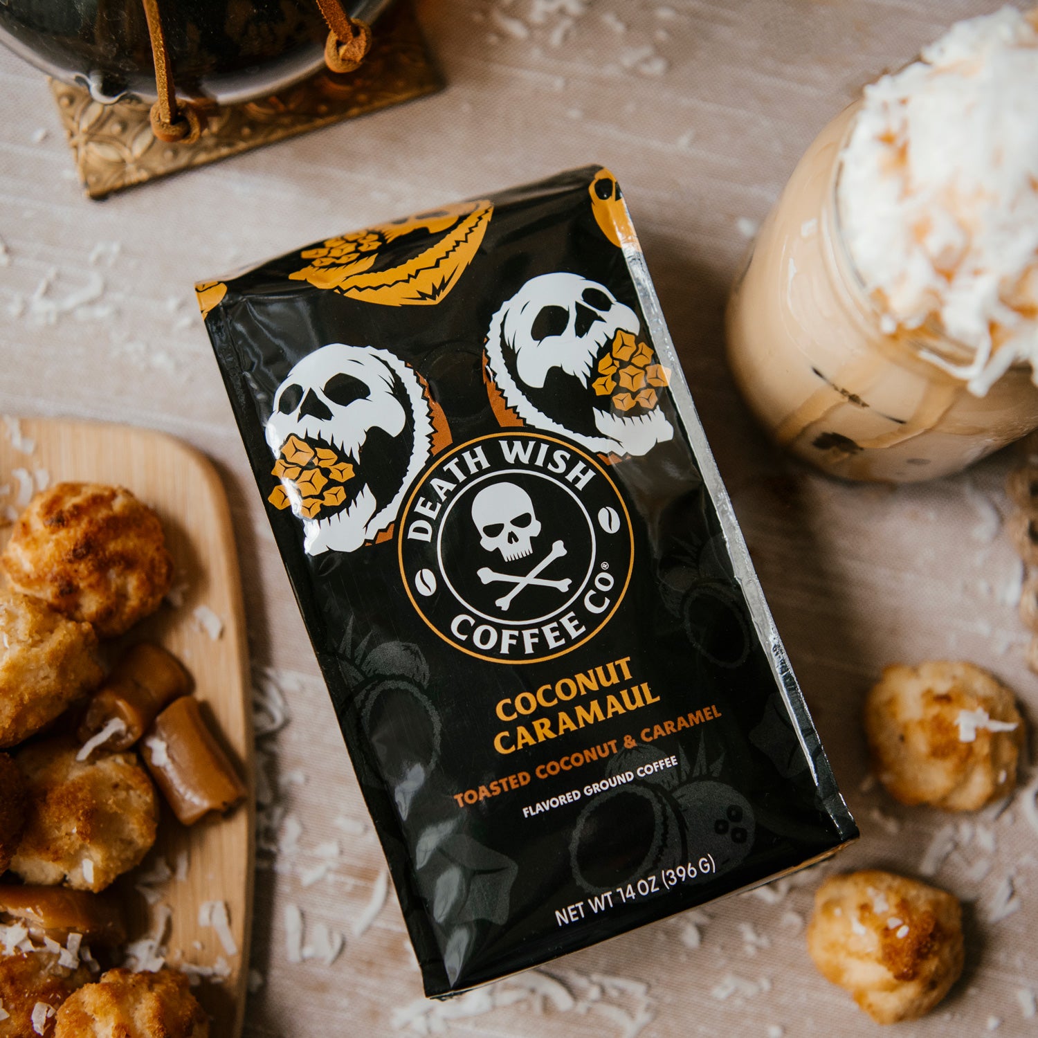 Death Wish Coffee Coconut Caramaul Flavored Coffee surrounded by pieces of caramel, coconut and other sweet treats.