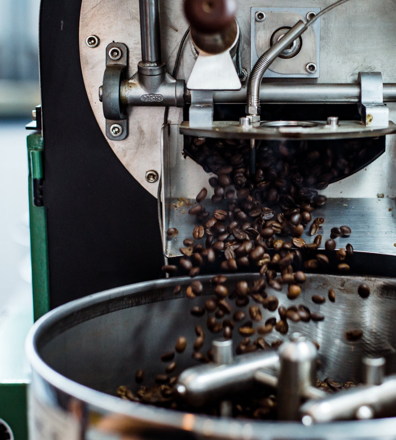 Coffee beans being poured into a grinder