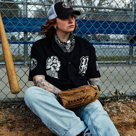A Pitch Black team member waiting by the dugout for their at bat.