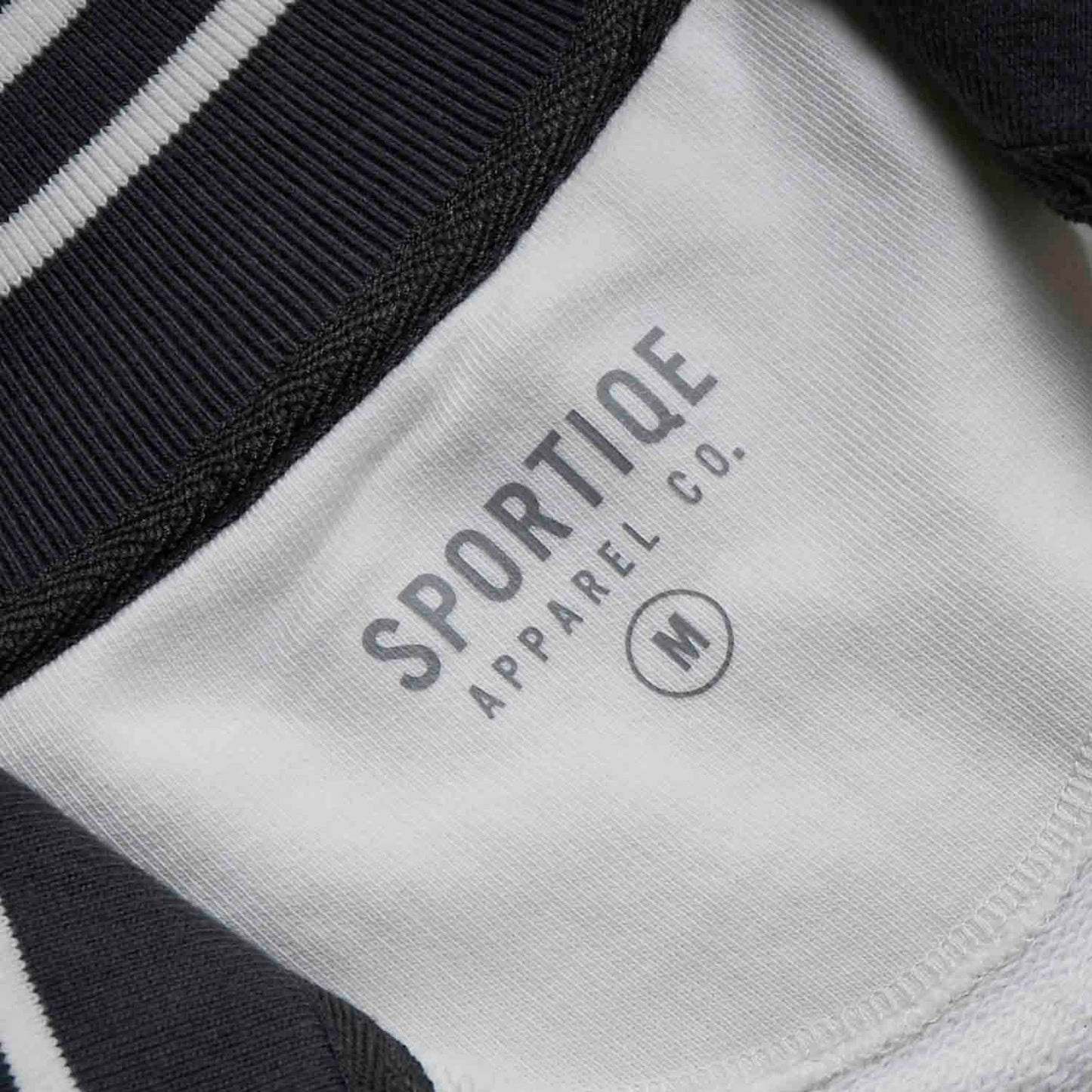 The inner neck label of the Death Wish Coffee After Hours Women's Full Zip Jacket.