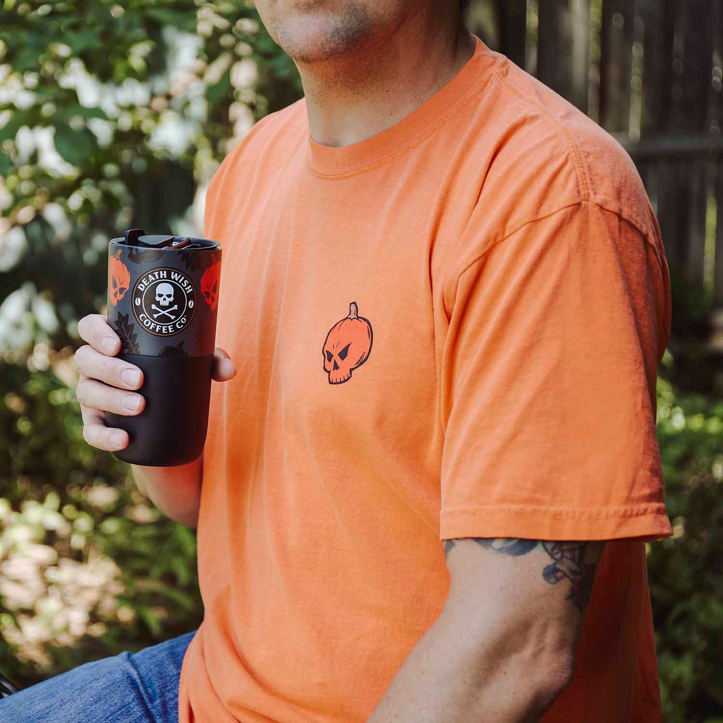 A model holding the Death Wish Coffee Pumpkin Chai Klean Kanteen (16oz).