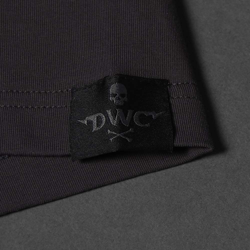 A black woven label sewn into the left hip of the Death Wish Coffee Erebus Embossed Tee.