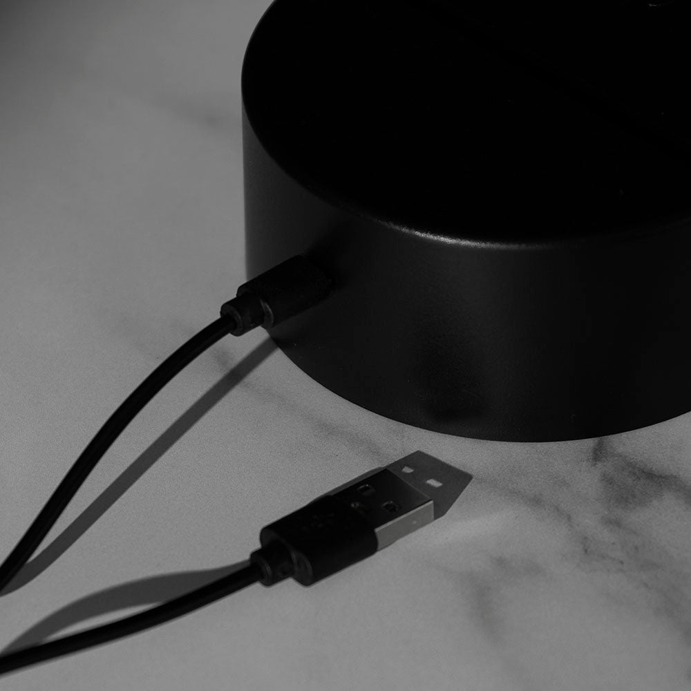 A close up of the Death Wish Coffee Neon Necromancer LED Light plugged in to charge.