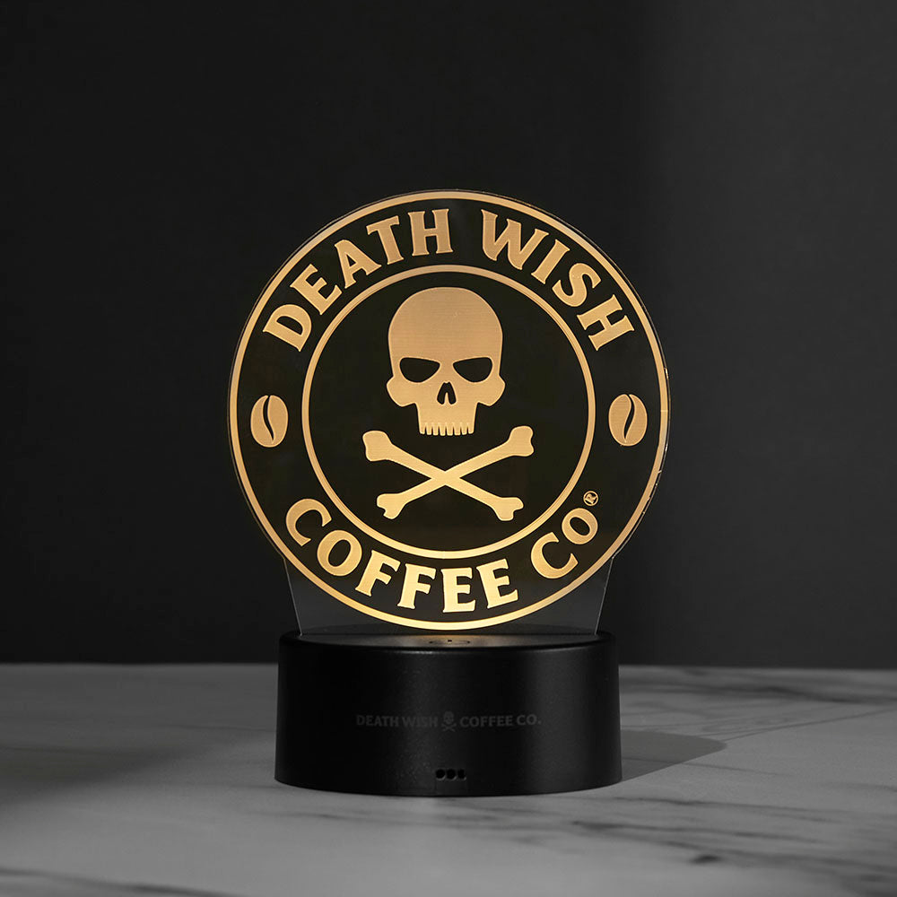 The Death Wish Coffee Neon Necromancer LED Light lit up using the skull and crossbones logo insert.
