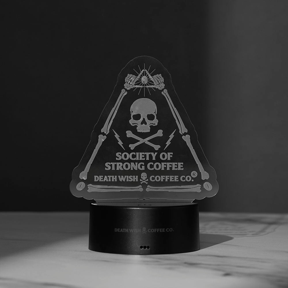 The Death Wish Coffee Neon Necromancer LED Light with the Society of Strong Coffee acrylic insert turned off.