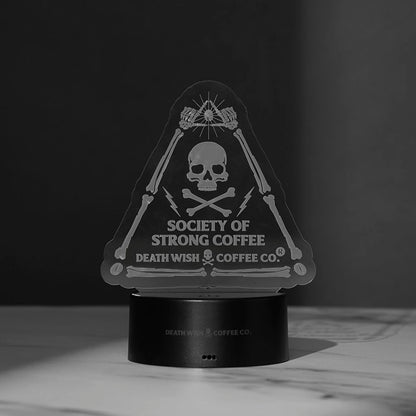 The Death Wish Coffee Neon Necromancer LED Light with the Society of Strong Coffee acrylic insert turned off.