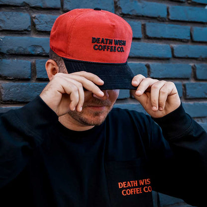 A model wearing the Death Wish Coffee Two-Tone Coffee & Cord Snapback.