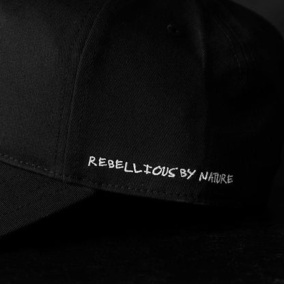 A close up of the Rebellious by Nature embroidery on the Death Wish Coffee Black Rebellious By Nature Snapback.