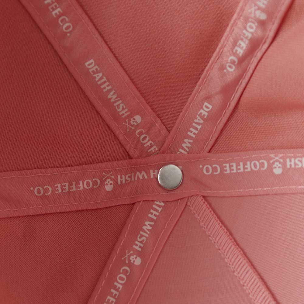 The custom interior taping of the Death Wish Coffee Pink Rebellious By Nature Snapback.