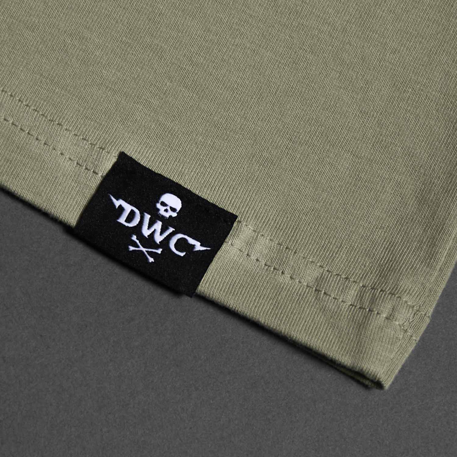 The woven hem label of the Death Wish Coffee Dropout Collegiate Tee.